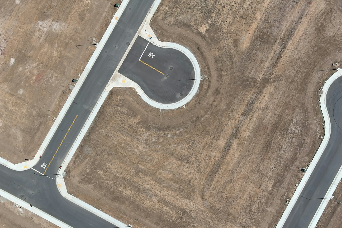 Newly paved roads and sidewalks in a residential development.